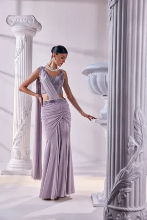 Draped Saree In Luxurious Shimmer Lycra Designed In Lilac Colour, An Emroidered Corset And A Belt.